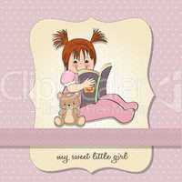 sweet little girl reading a book