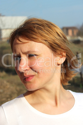 blue-eyed sympathetic girl looking at the sky