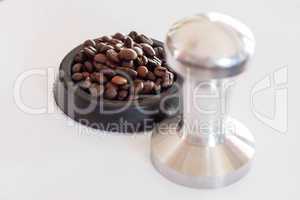 Aluminum tamper and roasted coffee bean for barista