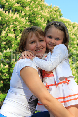 mother and daughter hugging one another