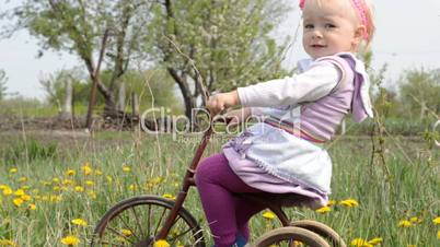 Cute baby on bicycle. Dolly shoot.
