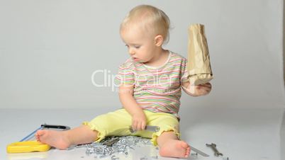 baby playing with tools