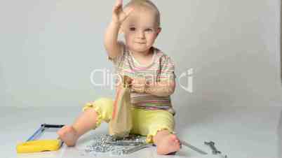 baby playing with tools