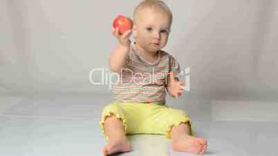 baby playing with apples