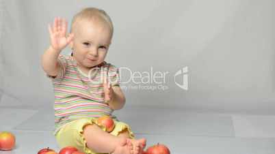 baby playing with apples