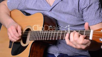 man playing guitar close up