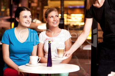 Two beautiful young girls at coffee shop