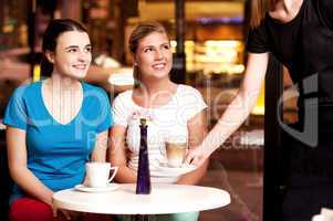 Two beautiful young girls at coffee shop