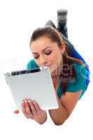 Relaxed young woman surfing on tablet device