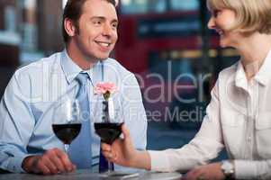 Happy couple drinking red wine at a restaurant