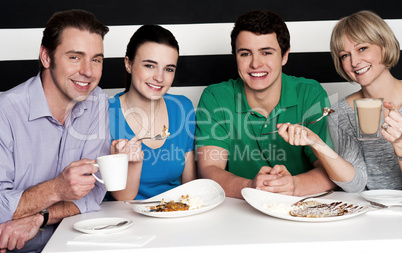 Happy family of four at restaurant