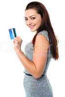 Fashionable young girl holding up a credit card