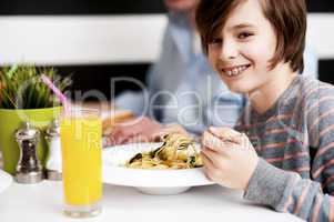 Boy enjoying food and fresh juice