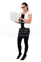 Female secretary using laptop