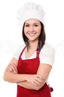 Cheerful confident young female chef