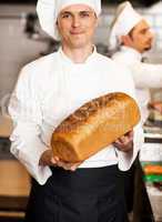 Chef showing freshly baked whole grain bread