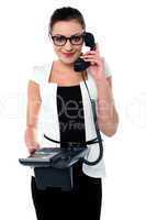 Bespectacles secretary answering a call