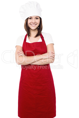 Young female chef with folded arms