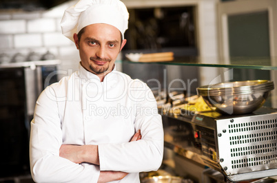 Confident young chef posing