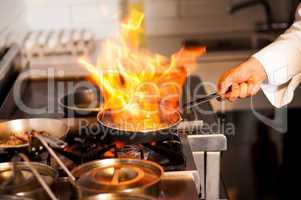 Chef cooking in kitchen stove
