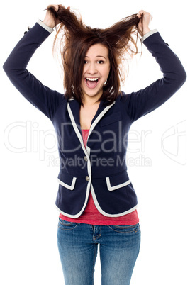 Young girl pulling her hair in excitement