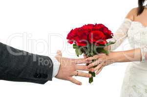 Bride offering rose bouquet to the groom