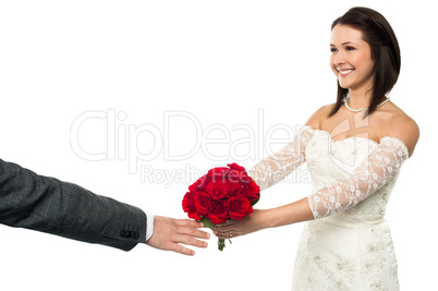 Bride offering her token of love to the groom