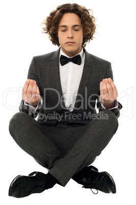 Guy in tuxedo striking a lotus posture