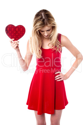 Girl holding valentine gift looking down