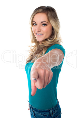 Cute young girl pointing you out