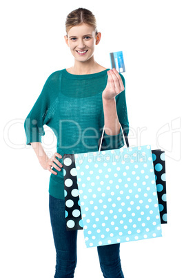 Girl holding shopping bags and credit card