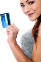 Fashionable young girl holding up a credit card