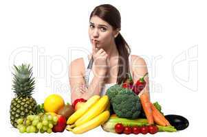 Mischievous look of a young woman with fruits