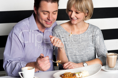 Couple rejoicing their meal in food court