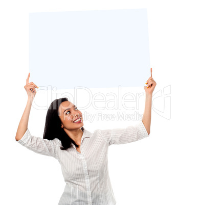 Woman holding up a blank white billboard