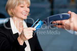 Corporate lady swiping her card to pay