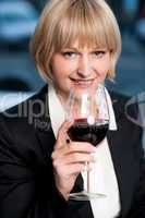 Corporate lady drinking red wine