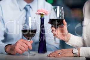 Business people enjoying wine, cropped image