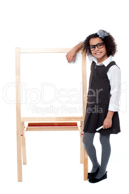 Bright student resting her hand on whiteboard