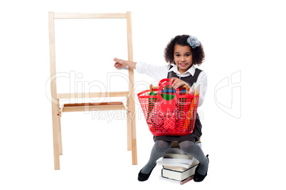 Young cute kid sitting on a pile of books