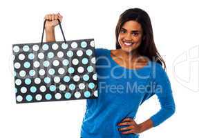 Pretty young model posing with shopping bag