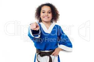 Smiling karate girl pointing towards you