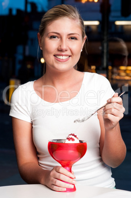 Beautiful woman enjoying tempting dessert