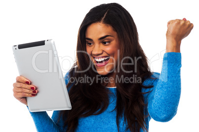 Excited woman holding touch pad