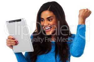 Excited woman holding touch pad