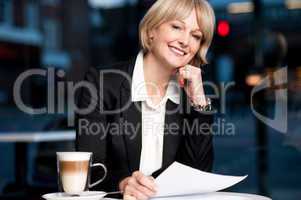 Female reviewing business report
