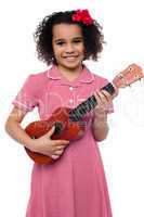 A little girl with a toy guitar