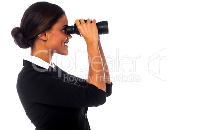 Corporate woman viewing through binoculars