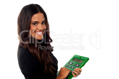 Businesswoman operating big green calculator