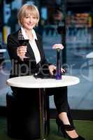 Gorgeous corporate woman enjoying red wine